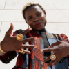 Image by freepikportrait-woman-posing-traditional-african-attire-outdoors