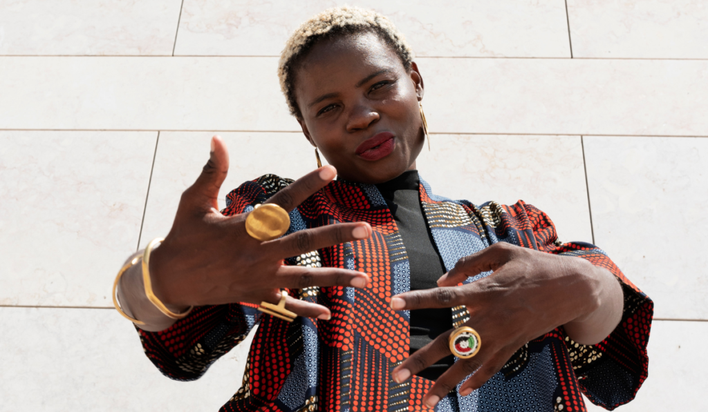 Image by freepikportrait-woman-posing-traditional-african-attire-outdoors
