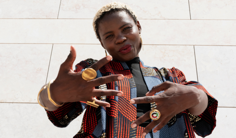 Image by freepikportrait-woman-posing-traditional-african-attire-outdoors
